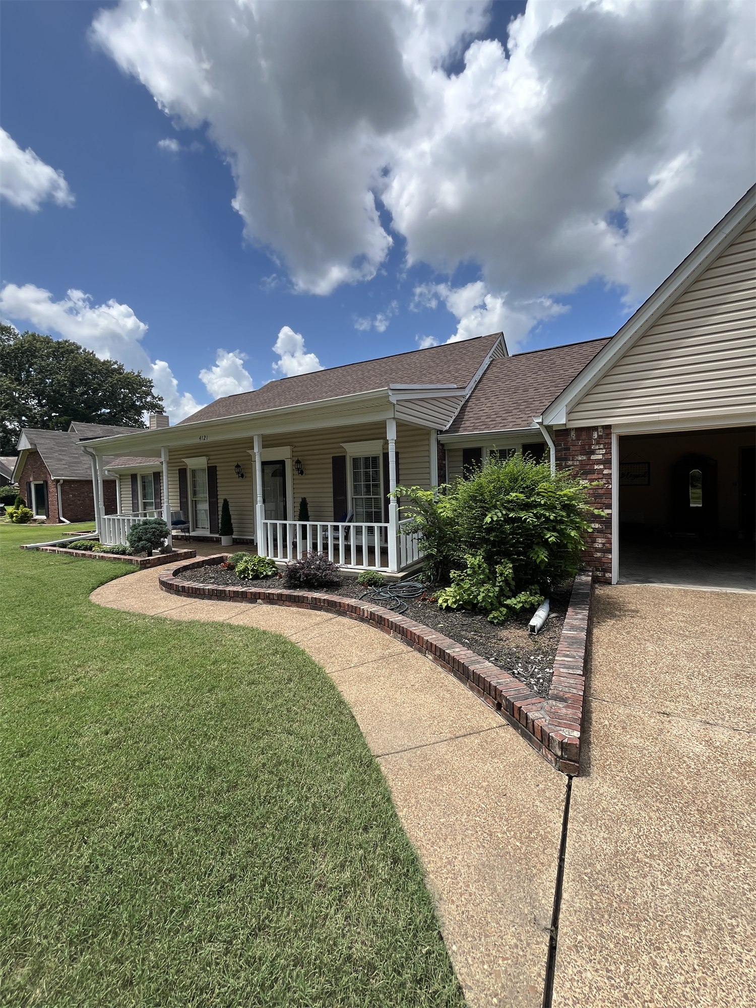 Cleaned concrete walk and driveway beside a house